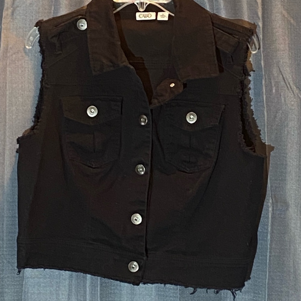 Woman’s size XL black jean vest sits at waist